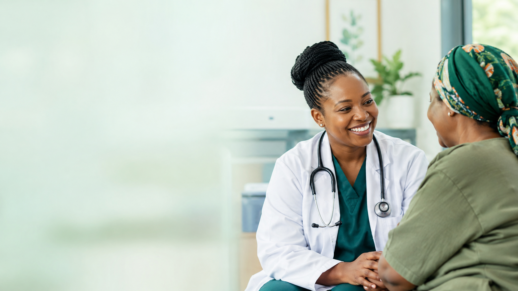 A Focus Clinical doctor smiling warmly with a patient during a consultation in a bright, modern clinic